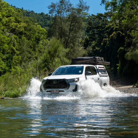 4WD Camper Crossing a Creek