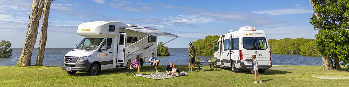 Families having a picnic by their motorhome