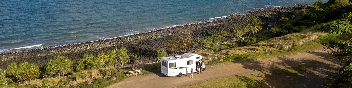 Couple by the sea with their motorhome